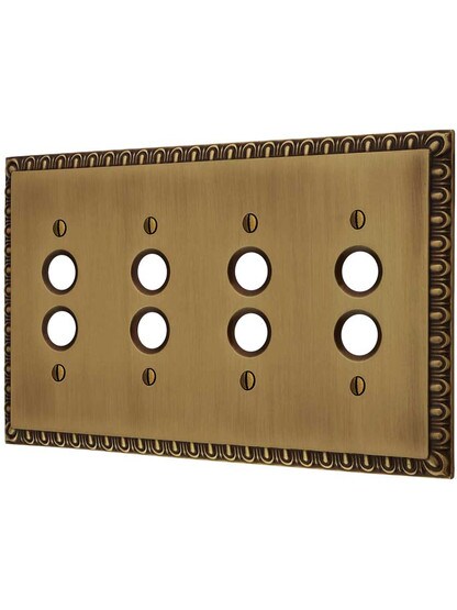 Ovolo Quad Gang Push-Button Switch Plate in Antique Brass.